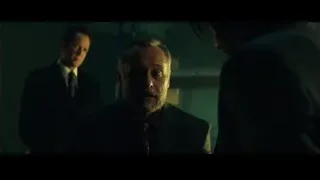 men in suits in dimly lit room — John Wick