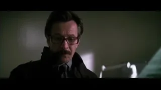 Man in dark suit with mustache in thought — Batman: The Dark Knight