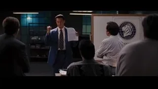 man in suit giving presentation — The Wolf Of Wall Street