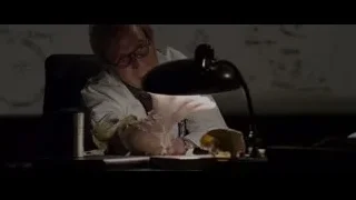 man in lab coat examining lizard on desk — The Amazing Spider Man