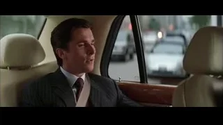 Man in suit looking out car window — Batman