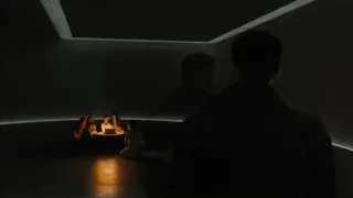 people gathered around table in dim room — Blade Runner 2049