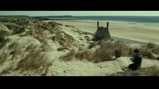 person sitting on sandy beach — Harry Potter and the Deathly Hallows 2