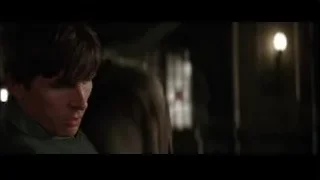 Young man adjusting tie in dark room — Batman
