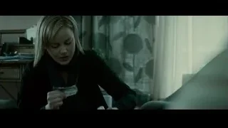 woman holding small object in room — Limitless