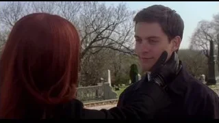 man and red-haired woman holding hands in cemetery — Spider Man