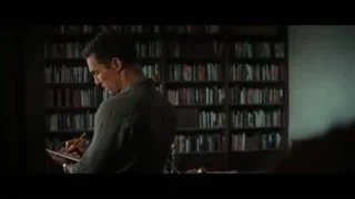 man with notebook in front of bookshelf — Interstellar