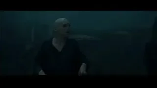 Bald man and cloaked figure in eerie castle environment — Harry Potter and the Goblet of Fire