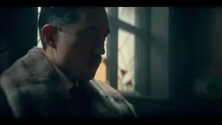 man holding gun at surprised man in dim room — Peaky Blinders
