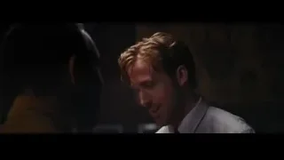 Blonde man in red tie in dimly lit room — La La Land