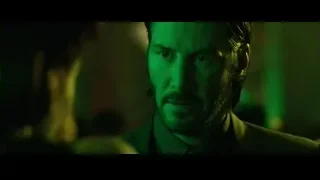 man in suit with beard looking serious — John Wick