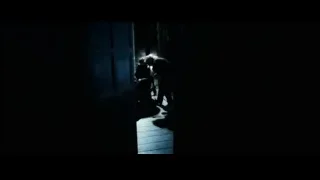 People with bowed heads in dimly lit hallway — Harry Potter and the Goblet of Fire