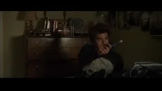 young man sitting on bed holding toothbrush — The Amazing Spider Man