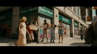 people walking with signs on busy street — The Dictator