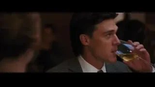 Young man in suit drinking from glass — La La Land
