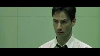 Close-up of man in suit against green wall — The Matrix