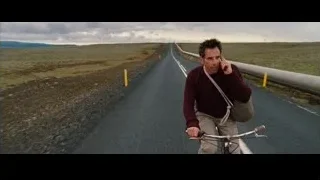 distressed man riding bicycle holding phone — The Secret Life of Walter Mitty