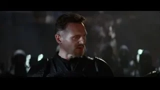 bearded man battle-ready in dark setting — Batman