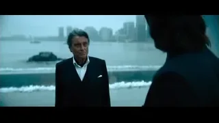 Man standing on pier looking at city skyline — John Wick: Chapter 4