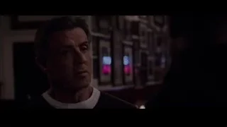 Close-up of man's serious face in dim room — Creed