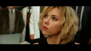 young woman with serious expression looking aside — Lucy