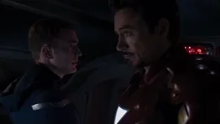 Iron Man conversing with man in dark room — The Avengers