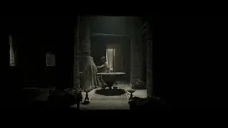 woman comforting man in dimly lit room — Gladiator 2