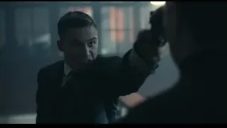 man in suit pointing gun at another man — Peaky Blinders