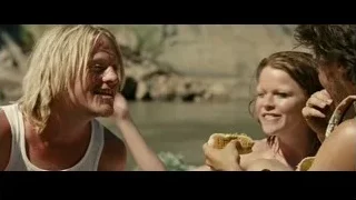 People eating sandwiches on sandy beach — Into the Wild
