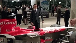 men around Formula One race car — Suits