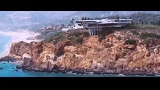 cliff overlooking ocean with building — Iron Man