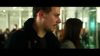 men conversing in airport terminal hallway — Lucy