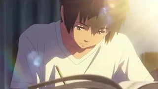 Young man reading book at desk — Your Name