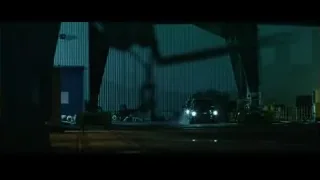car in industrial area with crane — John Wick