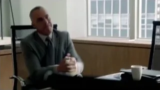 man in suit sitting at office desk — Suits