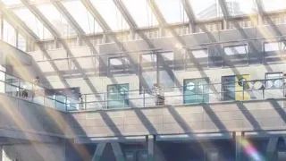 People walking on balconies of modern building — Your Name