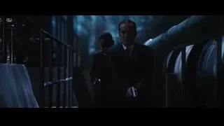 Two men in suits in dark hallway — Iron Man