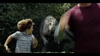 Young boy running towards large dinosaur — Jurassic World
