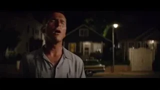 man standing in dimly lit street at night — Ford v Ferrari
