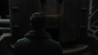 Man in black jacket in dimly lit room — Blade Runner 2049