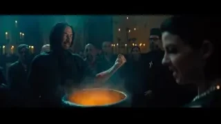 people gathered around cauldron in dark room — John Wick: Chapter 4