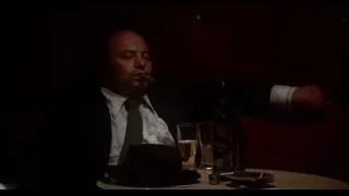 man with cigar at a table — Rocky III