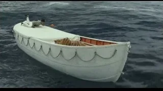 man and tiger on boat in ocean — Life of Pi