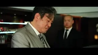 Man in suit holding pen in dim room — Lucy