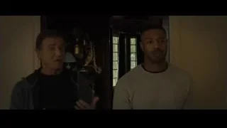 two men conversing, one on phone — Creed 2
