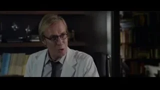 Man in lab coat sitting, deep in thought — The Amazing Spider Man