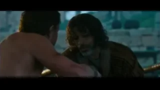 shirtless man with sword conversing in dim room — Gladiator 2