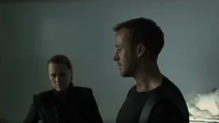 man and woman in dimly lit room — Blade Runner 2049