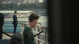 Man in suit on balcony overlooking city — Succession