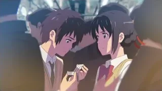 three people talking in crowded room — Your Name